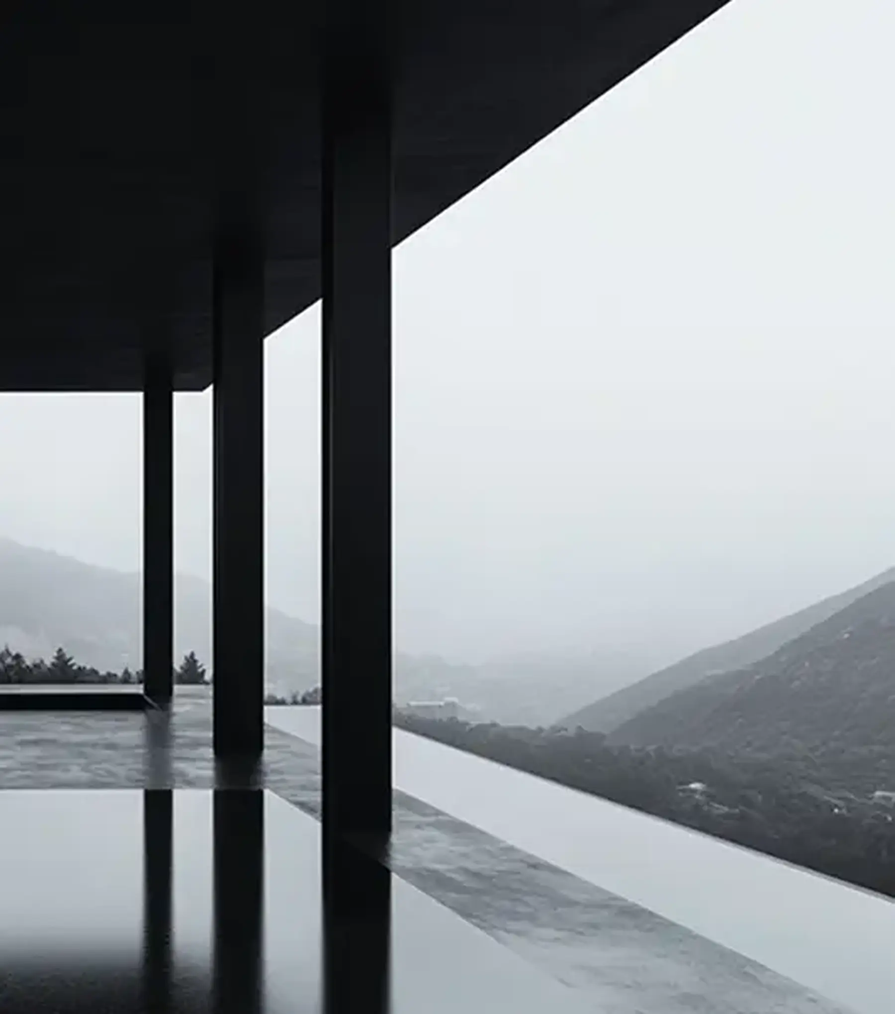 Covered terrace of a modern development overlooking misty hills