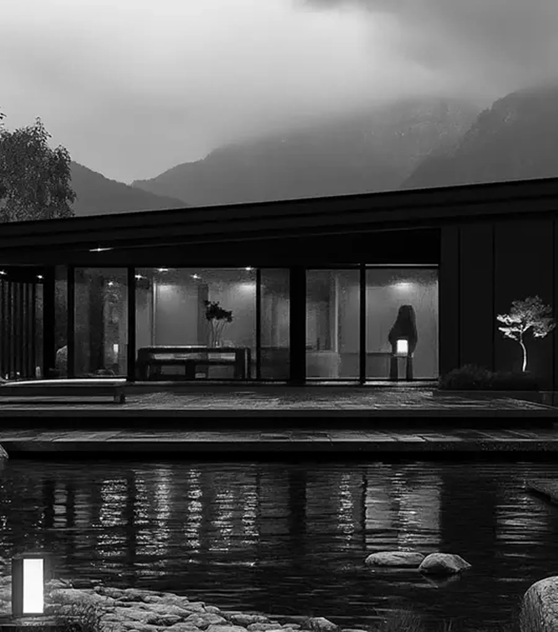 Modern single-storey home beside the water at dusk