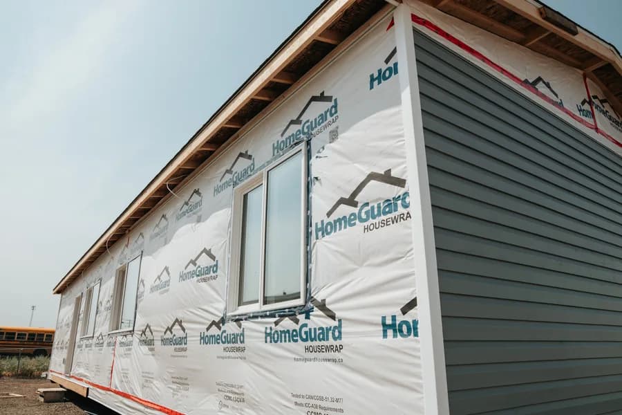 Siding going on a finished Herauf module in the yard