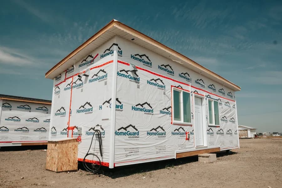 A completed Herauf module sheathed and housewrapped, staged outside the plant