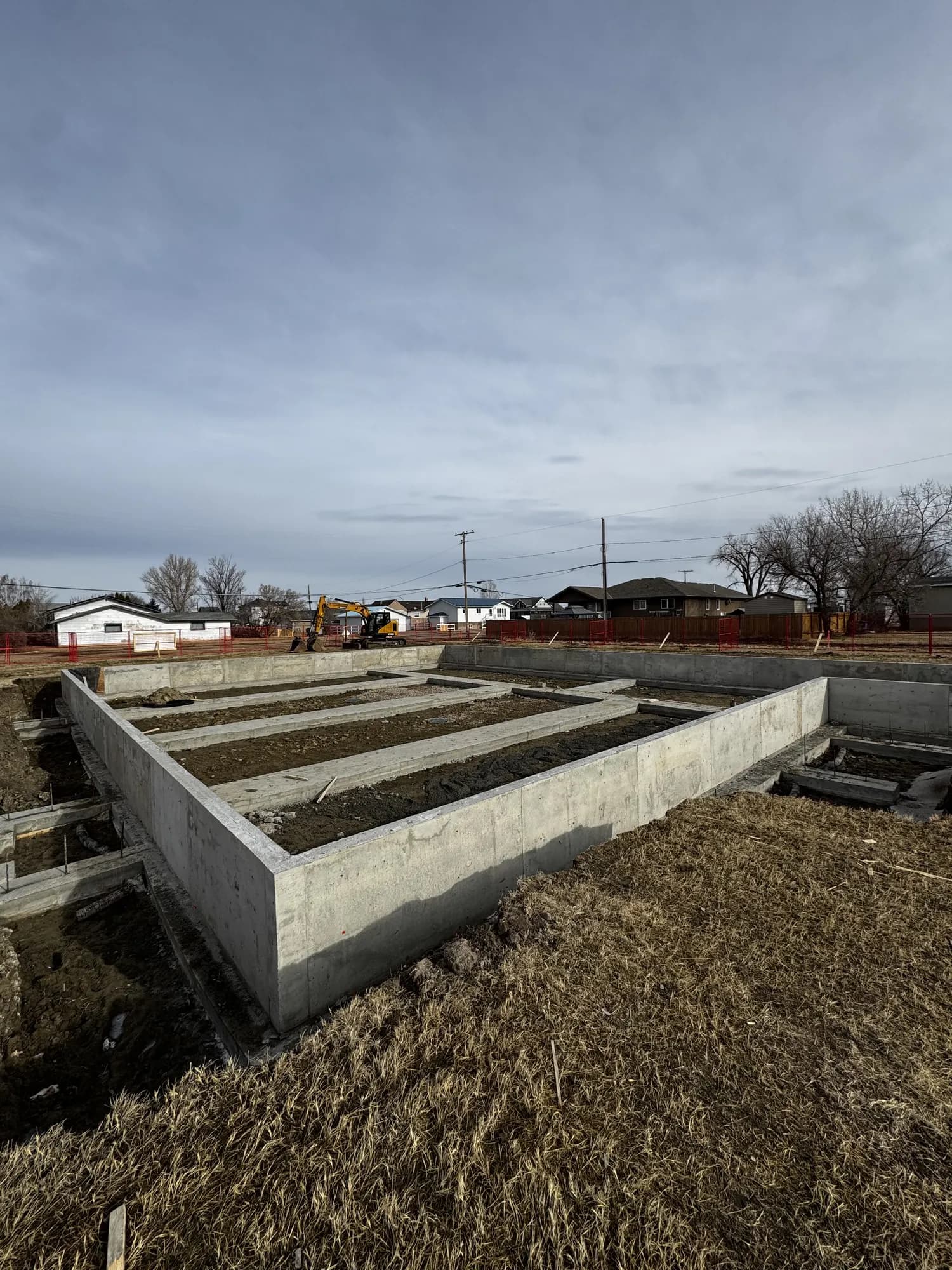 Finished concrete foundation walls and grade beams ready for module placement