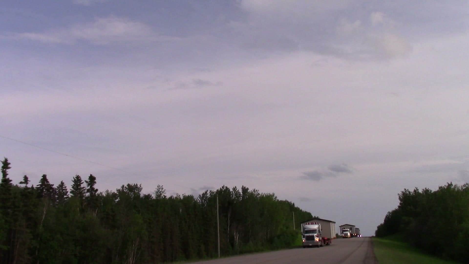 A convoy of Herauf modules on a northern highway, filmed with a helicopter overhead