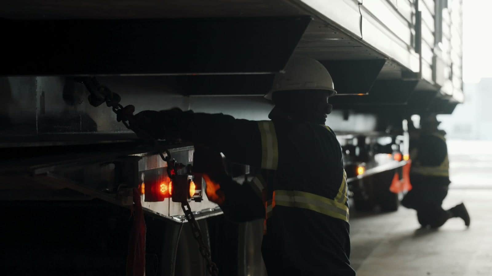 Crew chaining a finished module to its trailer